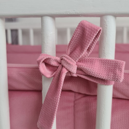 pink bumper made of velvet protector for crib