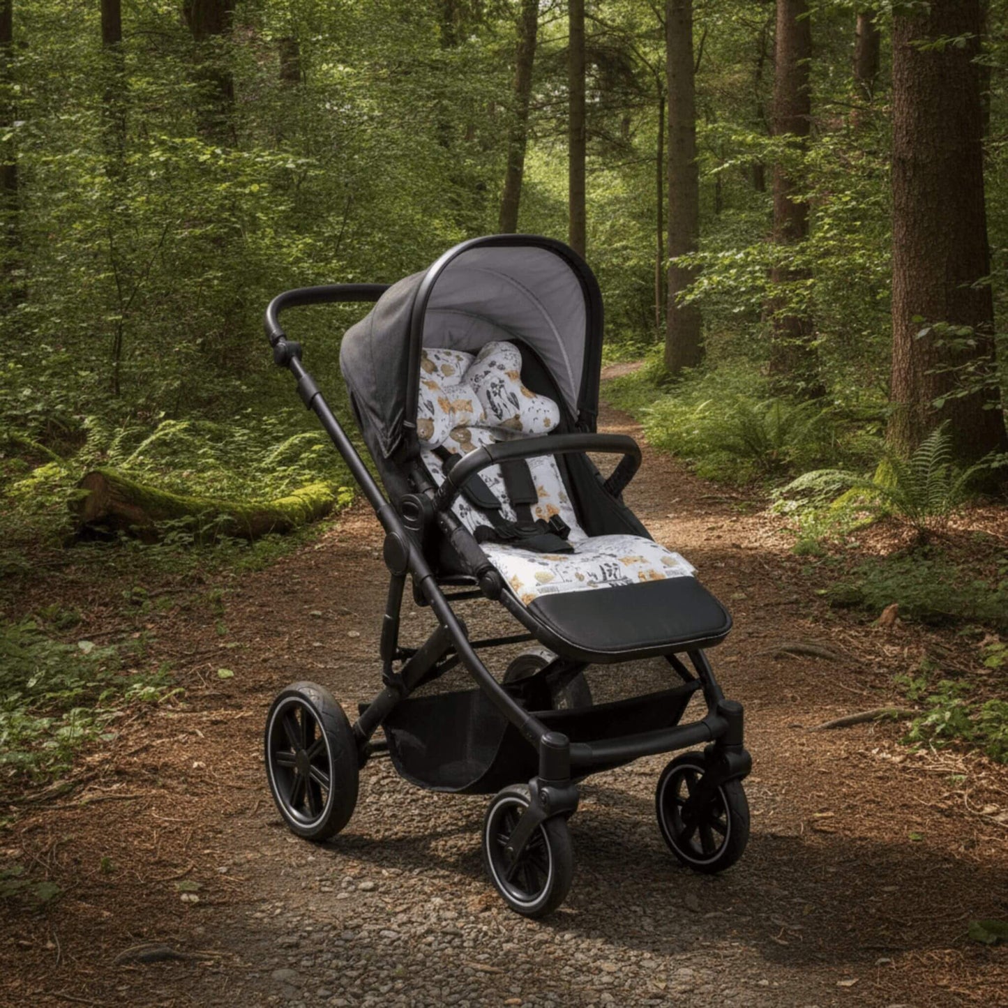 Evcushy Forest reversible stroller liner with matching head support pillow fitted inside a buggy. Soft padded cotton and velvet pram liner with washable footrest.