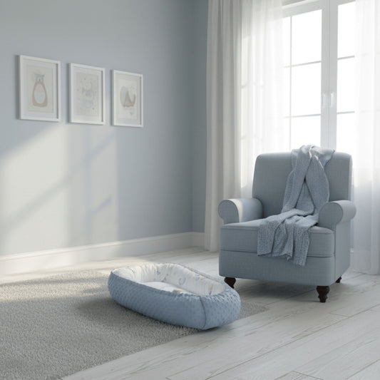 Light blue styled nursery with evcushy baby sleep nest in blue colour on the floor