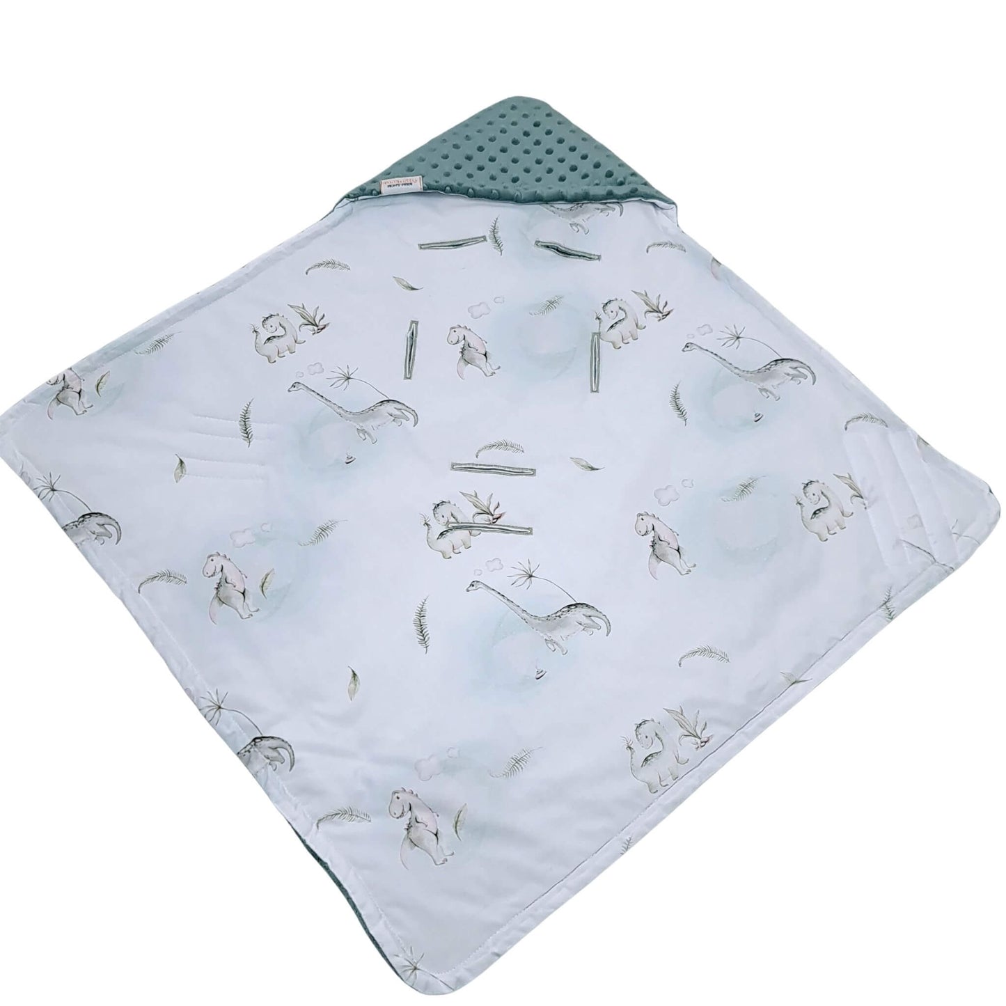 Close-up of Tiny Roars dinosaur and floral cotton pattern in soft green and white from Evcushy blanket collection