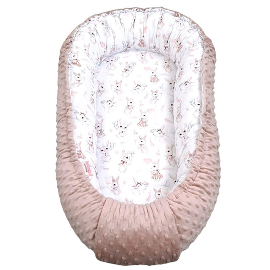 Baby nest with pink minky exterior and white with pink bunny pattern for newborn to 9 months