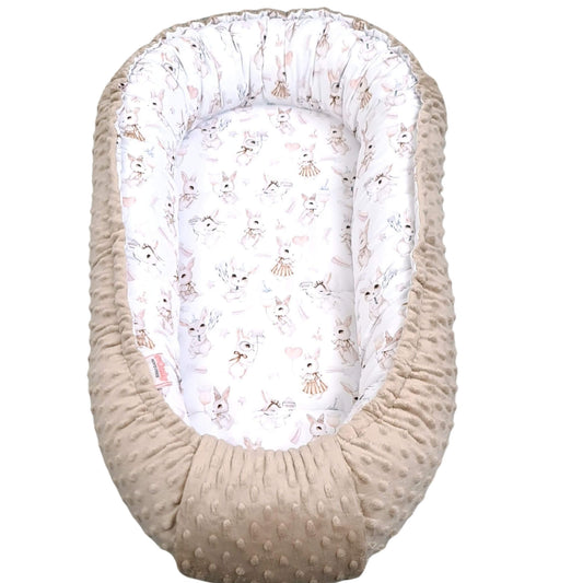 Baby nest with white lining featuring animal prints on a white background