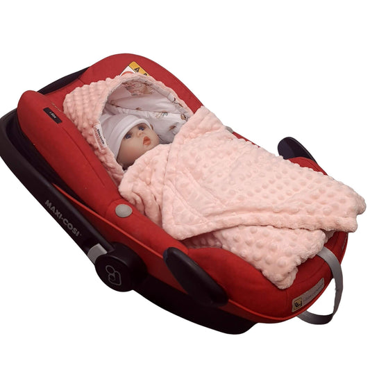 Newborn Baby wrapped in swans lotus blanket in car seat safely