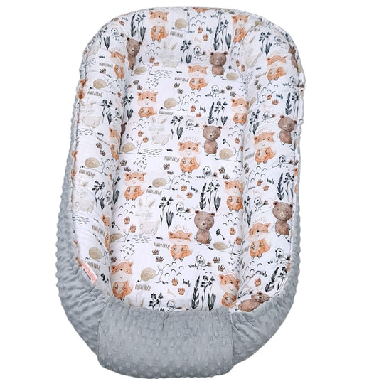 Baby nest toddler size with forest animal pattern on a white background top view

