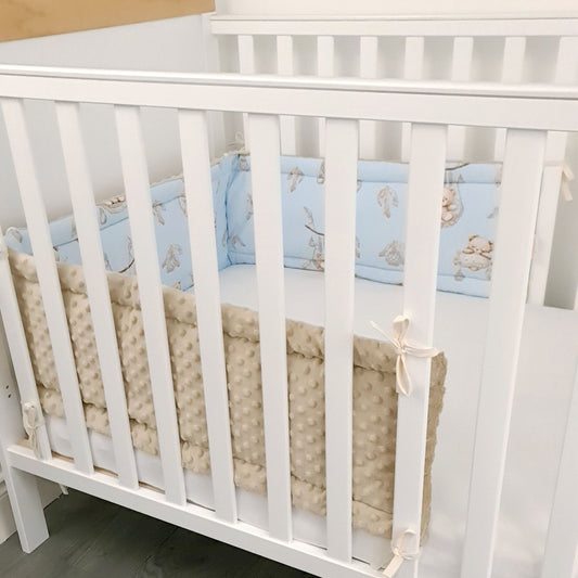 cot bumper featuring mokka bears on blue cotton in a wooden cot bed