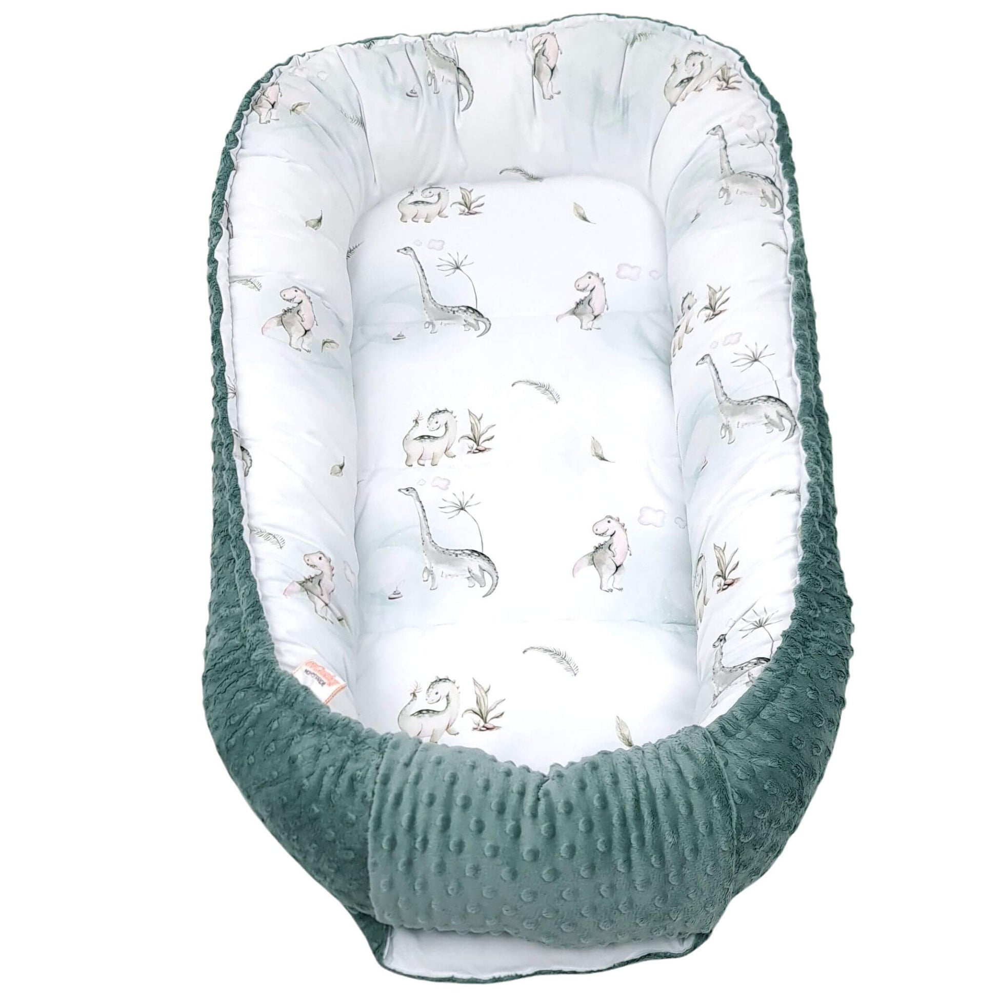 Close-up of friendly dinosaur pattern on white and mint cotton fabric with green edging  large sleeping pod for 6-36 months