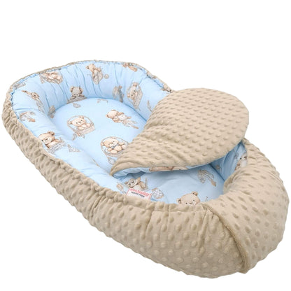 Side view of Evcushy beige teddy on blue baby nest pod with liner