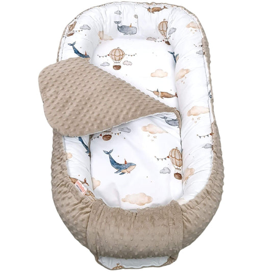 Top view of Mocha Mousse bottom baby nest with liner with whale and balloon pattern 6 months plus