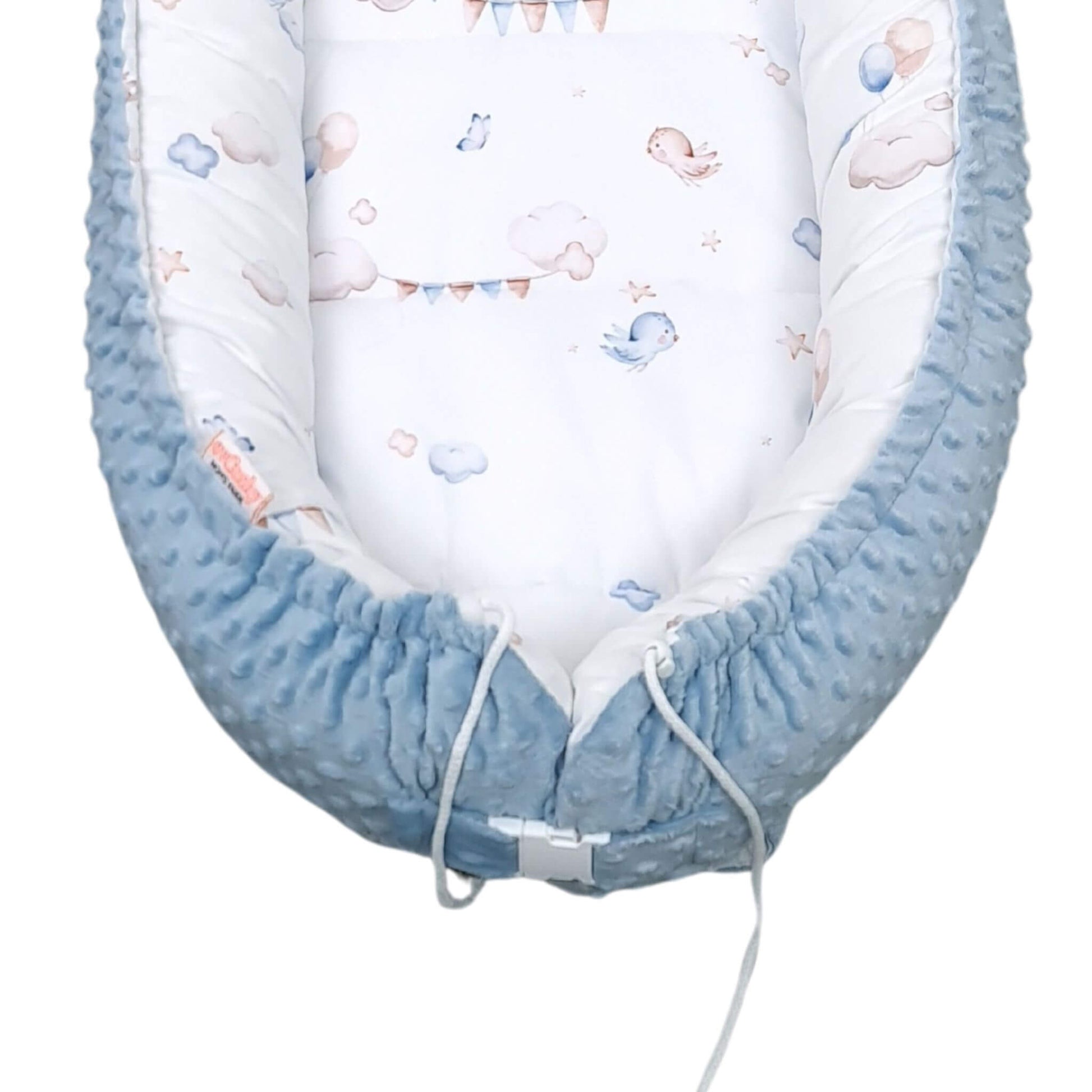 Close-up of blue dimple plush bottom of toddler nest, buckle closure 