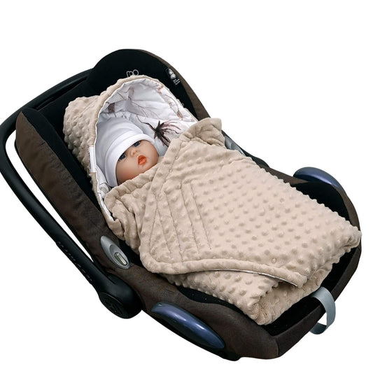 Newborn baby wrapped in Evcushy Cotton Blossom car seat blanket with floral cotton pattern and toupe plush fleece
