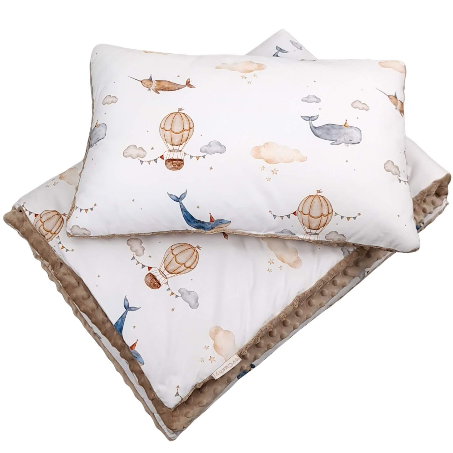 Baby pillow and blanket set with whale and hot air balloon pattern on a white background