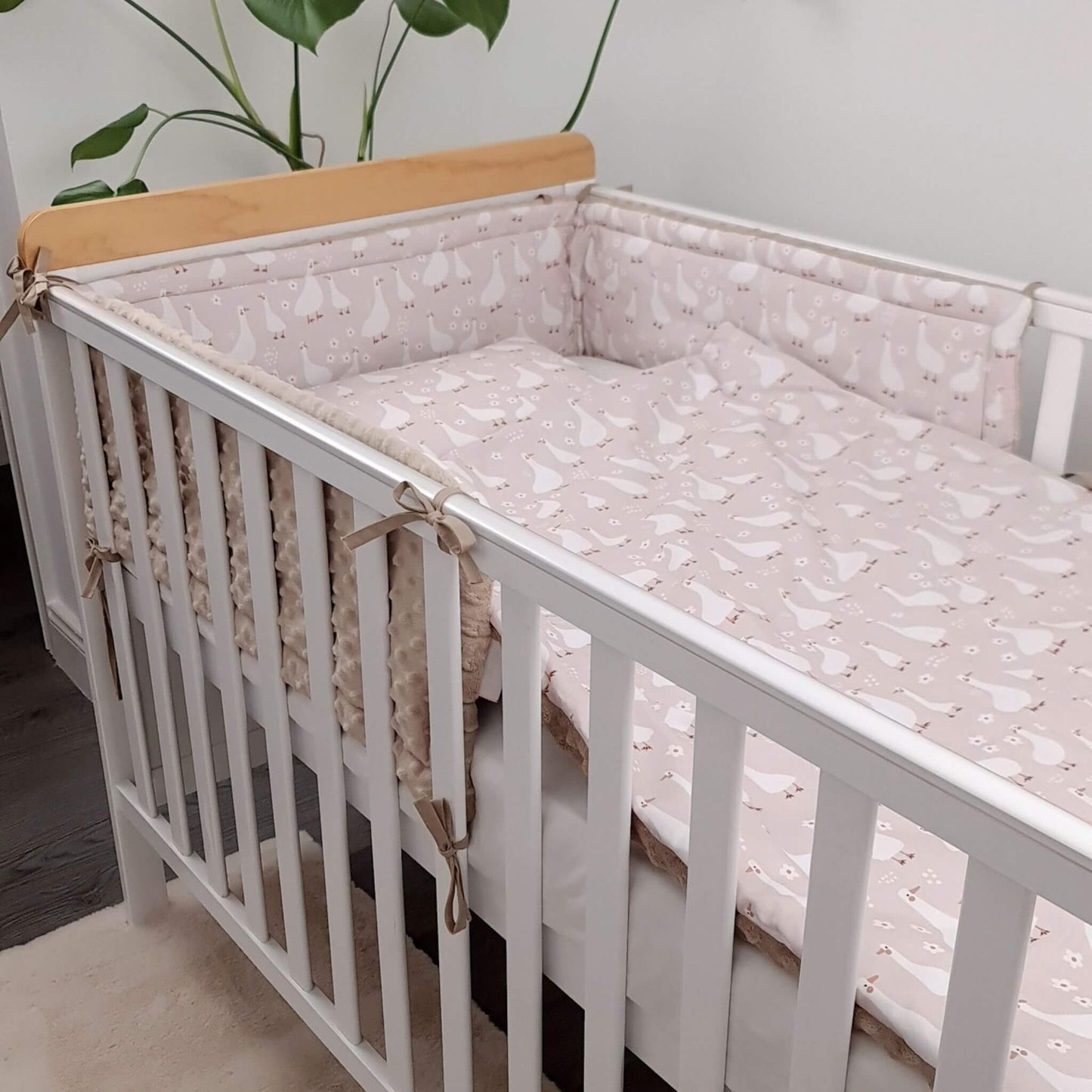 Evcushy Geese Family cot bed bumpers made from premium cotton and ultra-soft minky plush, displayed inside a baby's cot.