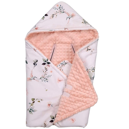 A baby hooded swaddle blanket for car seat and stroller featuring a light pink and white floral print on one side and a soft peach-pink minky dot textured reverse side, shown on a plain white background.
