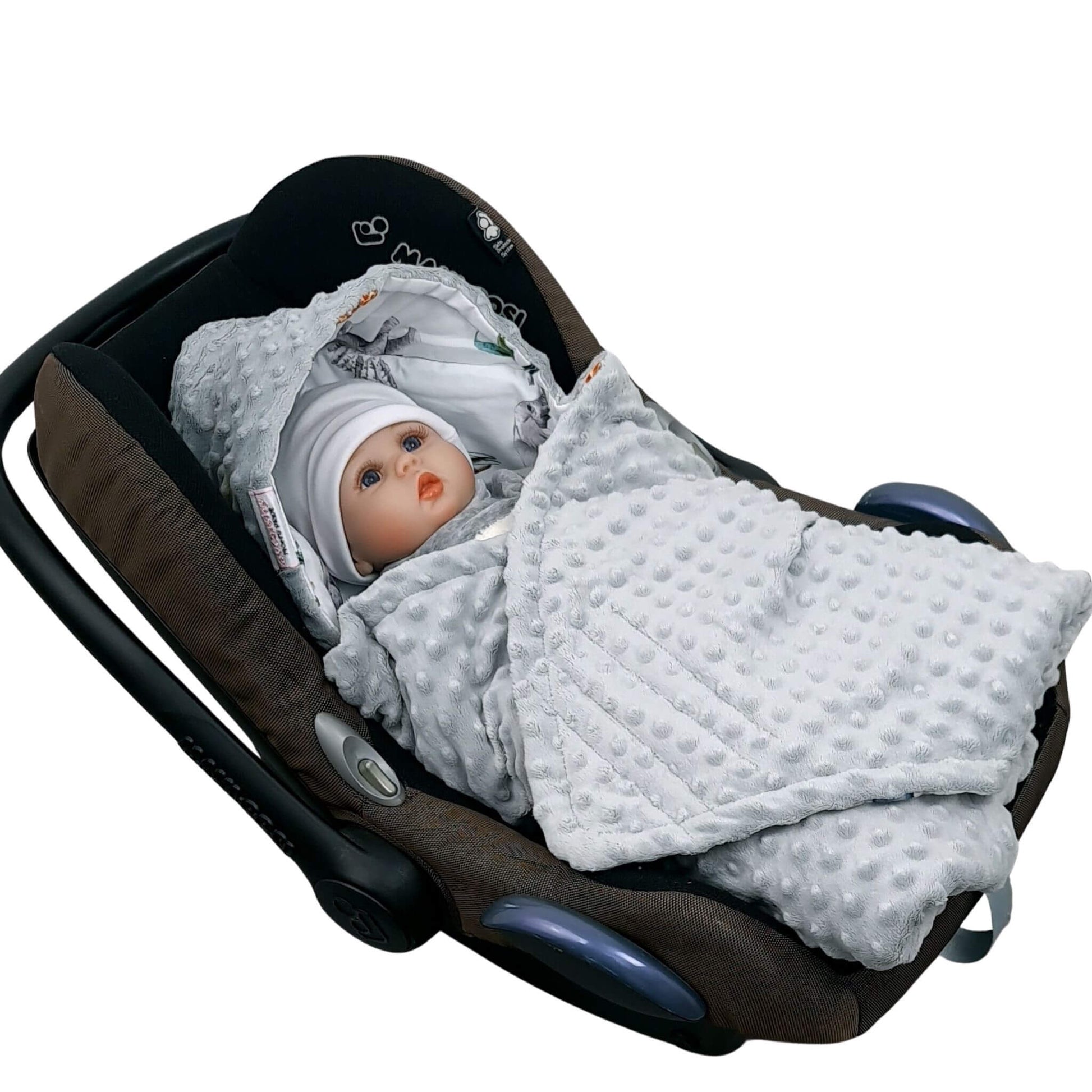 Newborn baby wrapped in Evcushy Safari Adventure car seat blanket with safari animal pattern and grey fleece