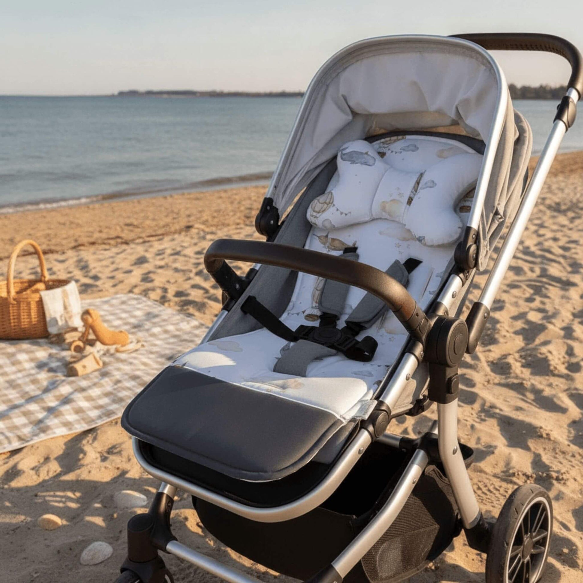 Evcushy Whales and Balloons reversible stroller liner with matching head support pillow fitted inside a buggy. Soft padded cotton and velvet pram liner with washable footrest.