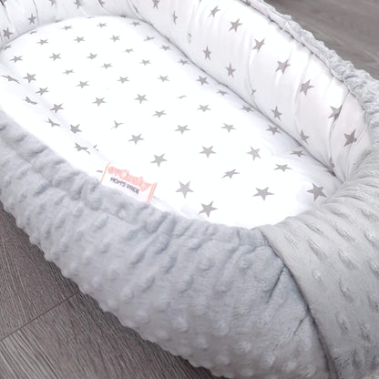 Close-up of plush grey minky fabric baby nest with white cotton grey star pattern – soft breathable newborn bedding by Evcushy
