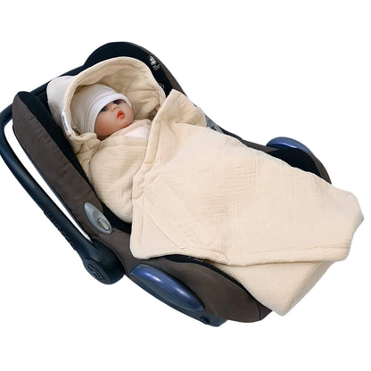 Baby wrapped in Evcushy breathable muslin blanket secured in car seat