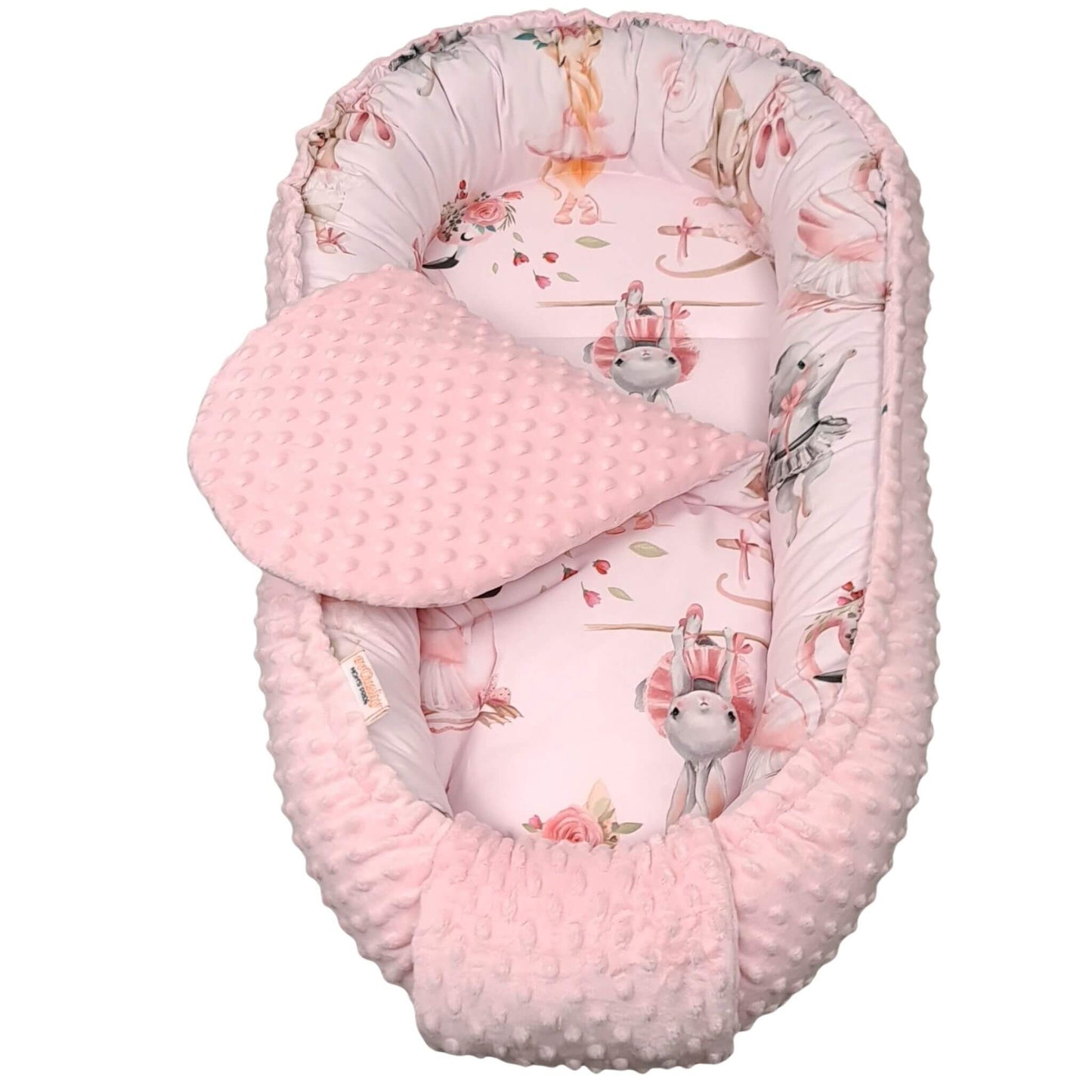 pink baby nest with insert for sleep and lounge with bunnies kittens ballerinas and swans designed in Ireland