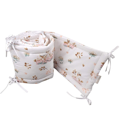 A baby crib cot bumper featuring elegant swans and delicate floral design made from breathable cotton in neutral colours