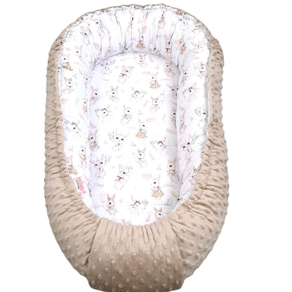 Baby nest with white lining featuring animal prints on a white background