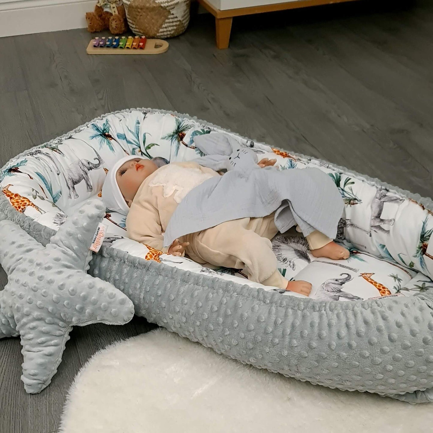Lifestyle photo of safari toddler nest set in a modern baby room.