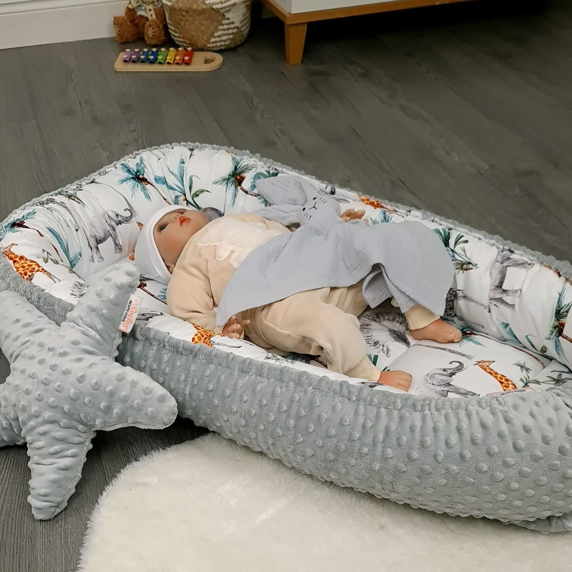 Lifestyle photo of safari toddler nest set in a modern baby room.
