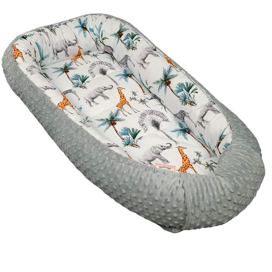 Toddler nest in safari pattern with elephants, giraffes and palms in grey and green colours.